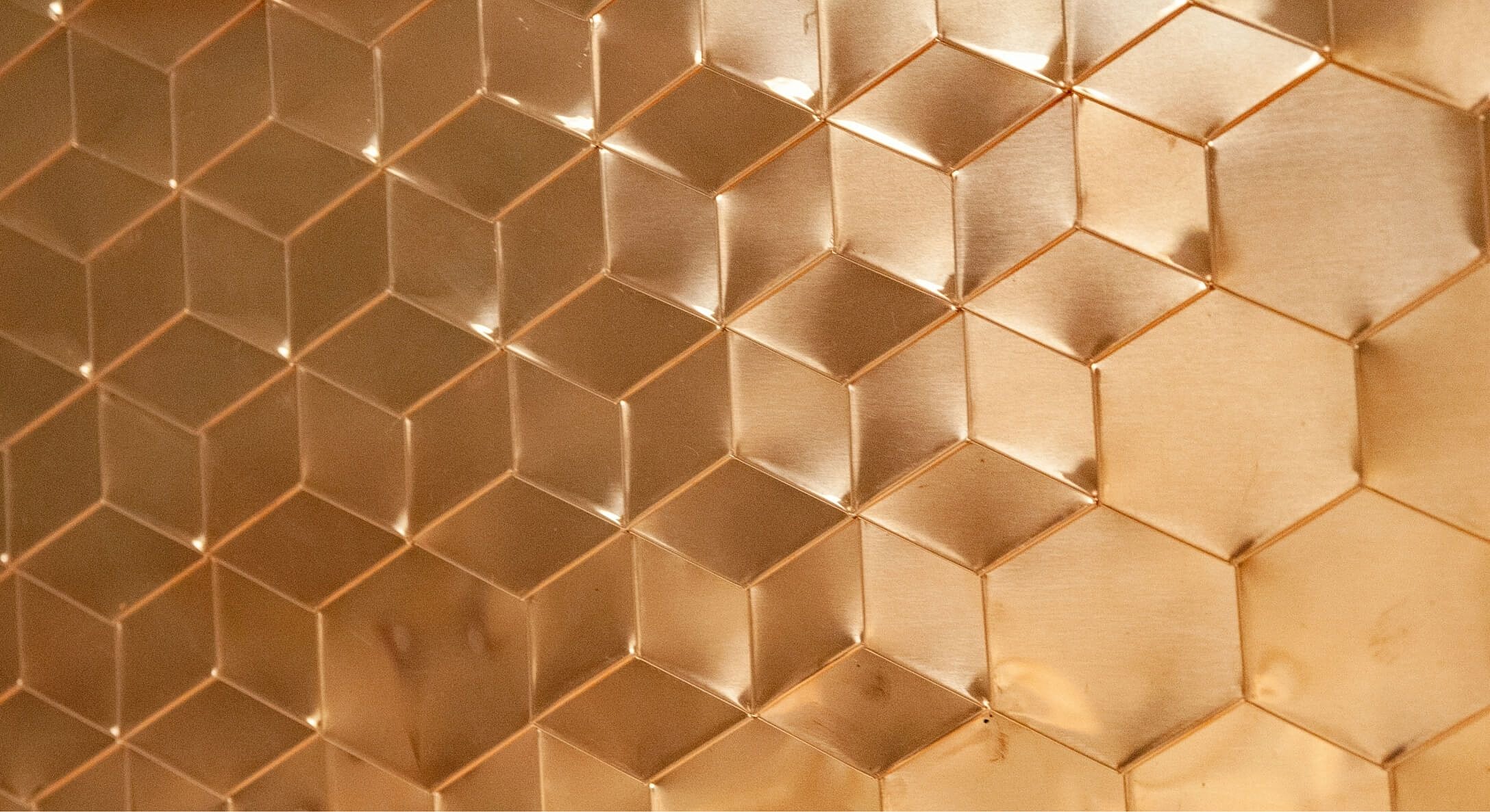 Textured hexagonal copper surface pattern.