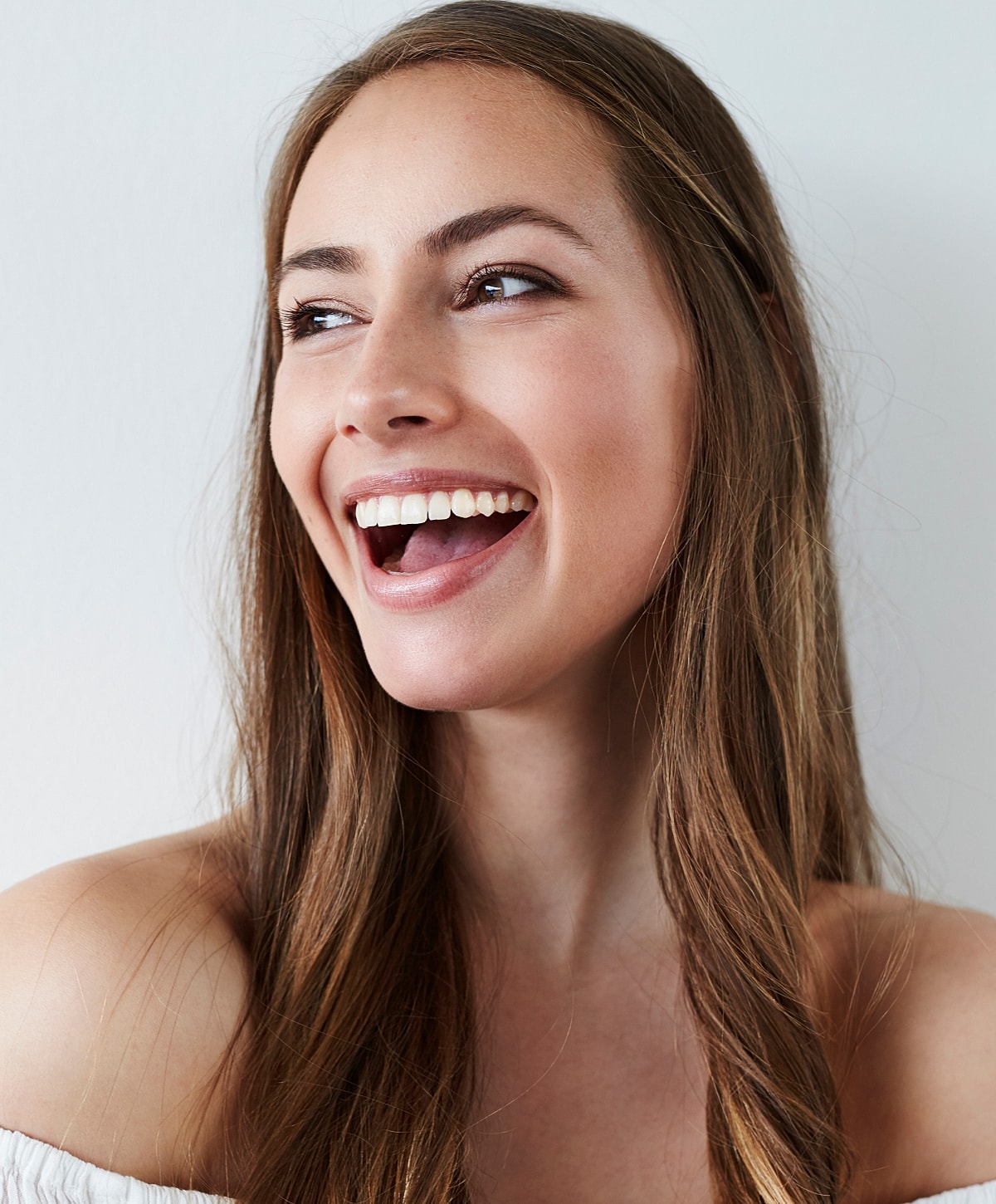 Woman smiling with long, brown hair.
