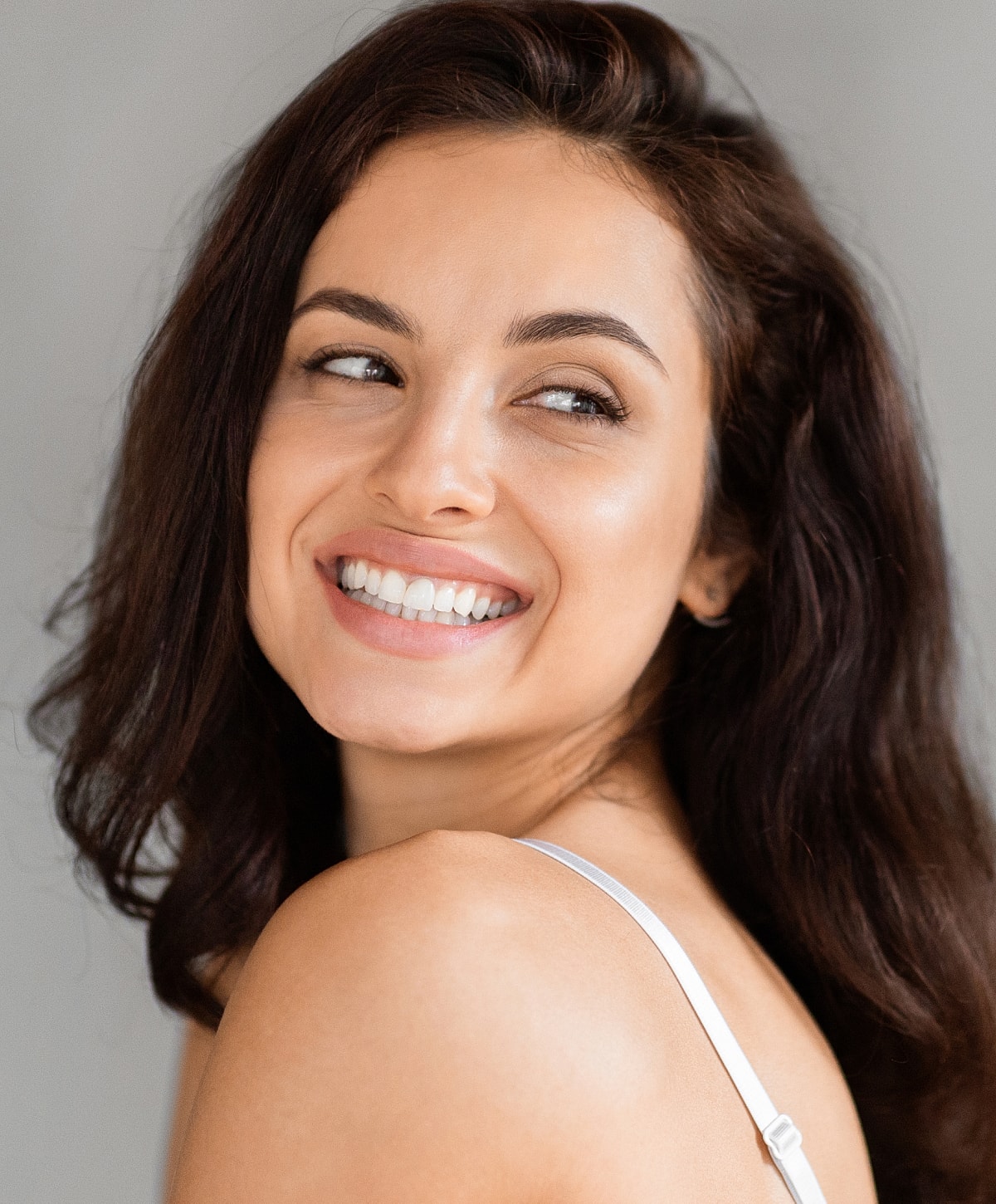 Smiling woman with dark hair, casual pose.