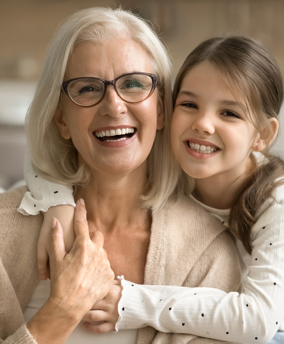 Smiling grandmother and granddaughter, joyful embrace.
