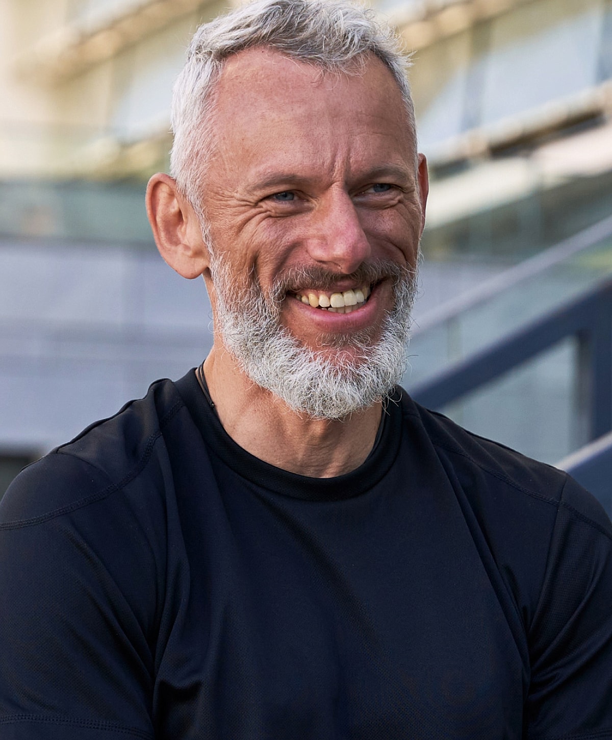 Smiling older man with a gray beard.