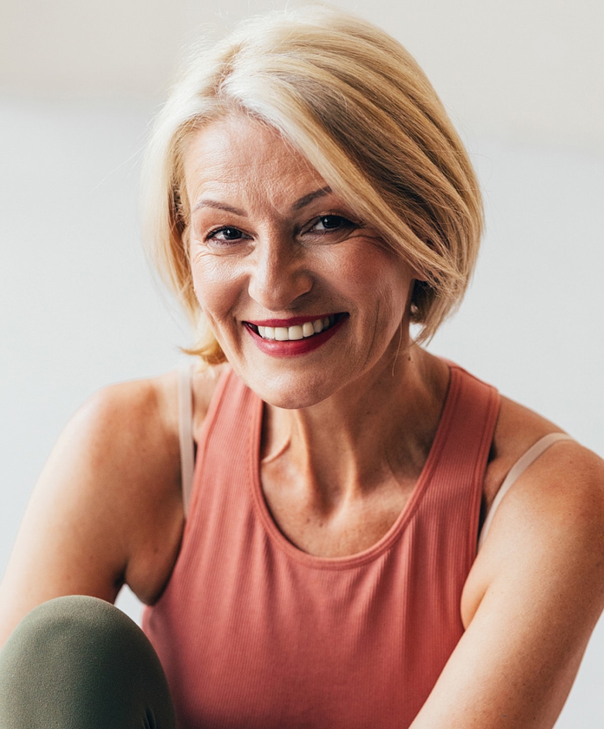 Smiling mature woman in fitness attire.