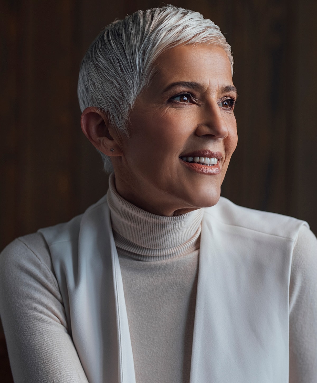 Smiling woman with short, silver hair in turtleneck.