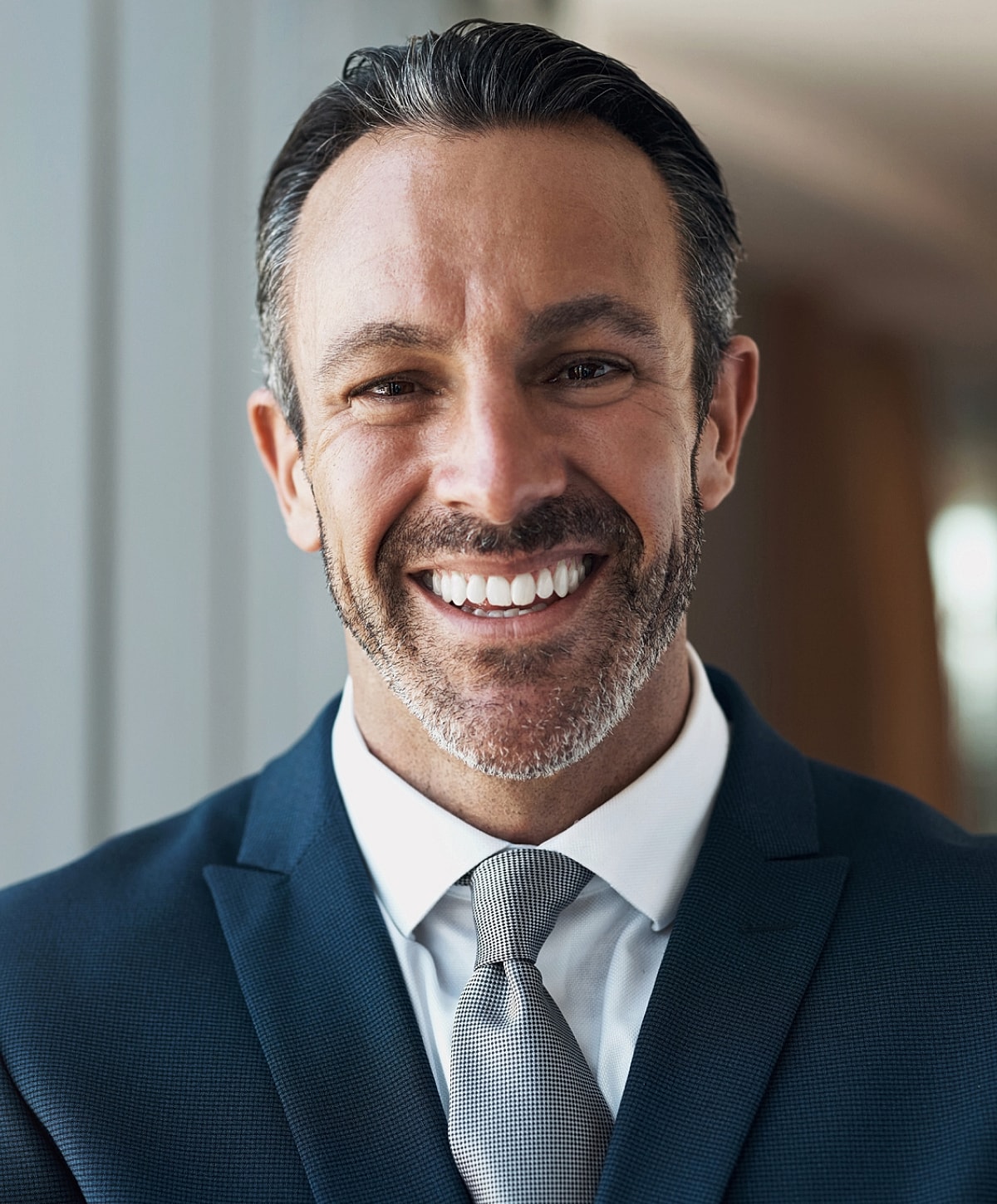 Smiling man in suit and tie portrait.