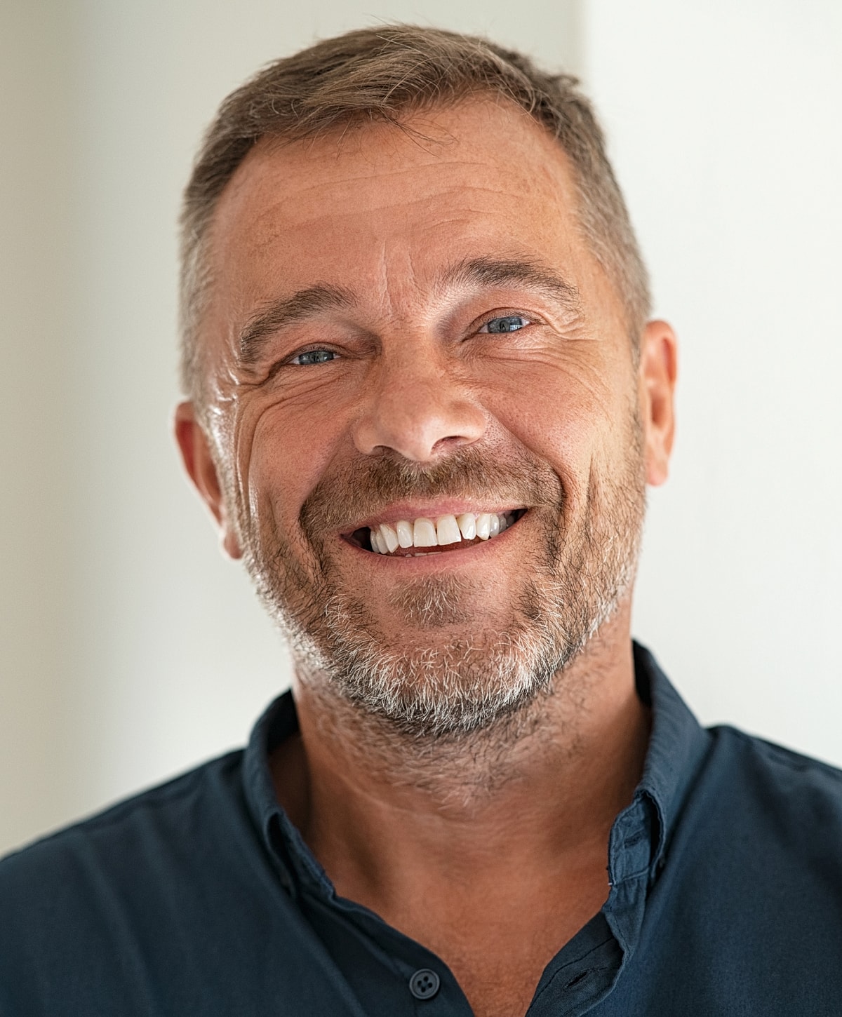 Smiling man with short hair and beard.