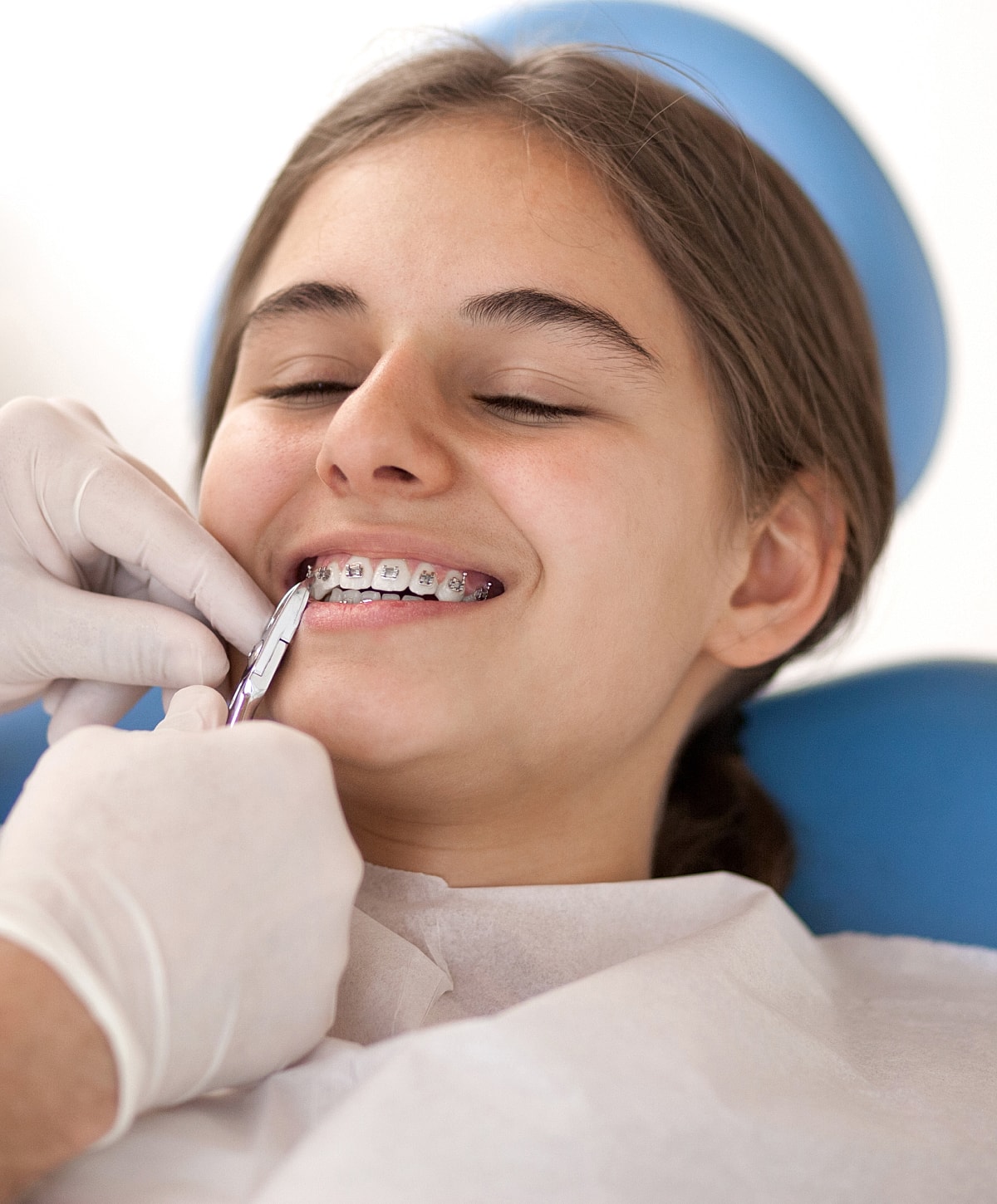 Teenager with braces at dental appointment.