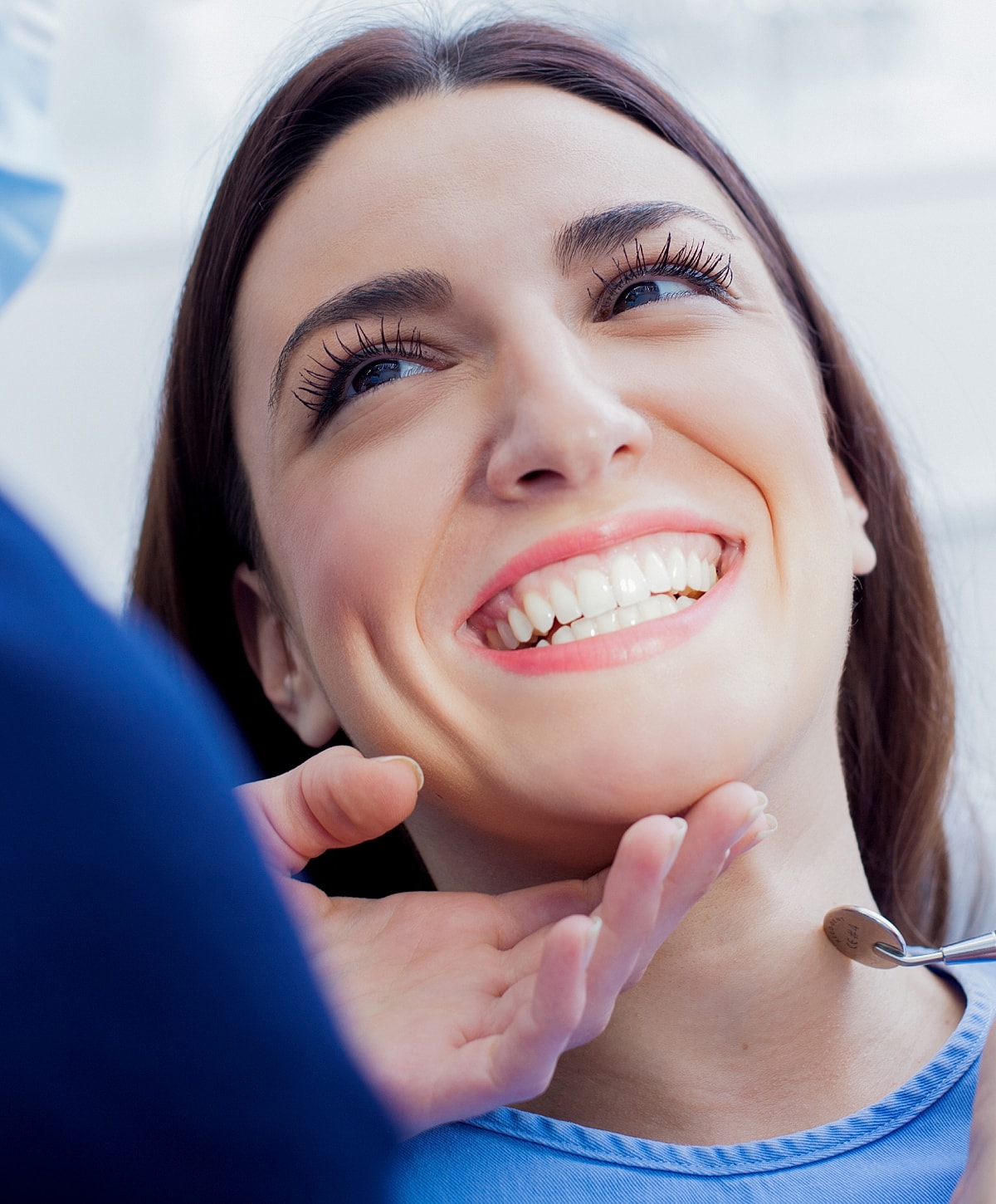 Patient smiling during dental check-up appointment.
