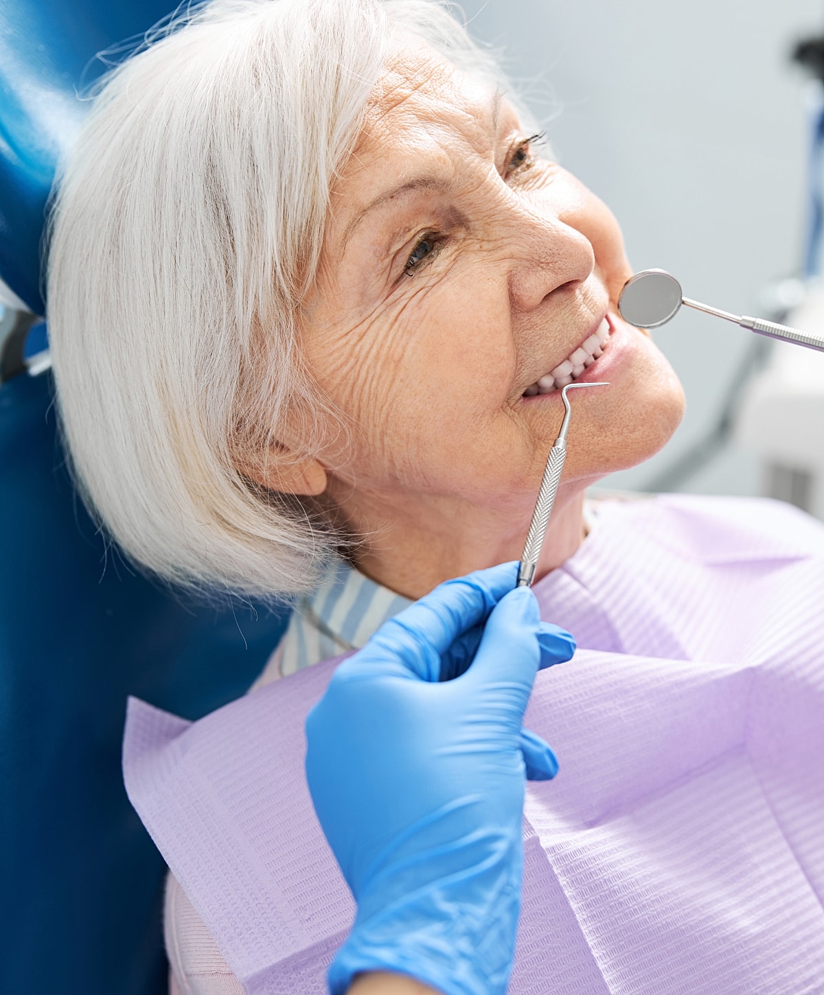 Elderly woman at dental check-up with dentist.