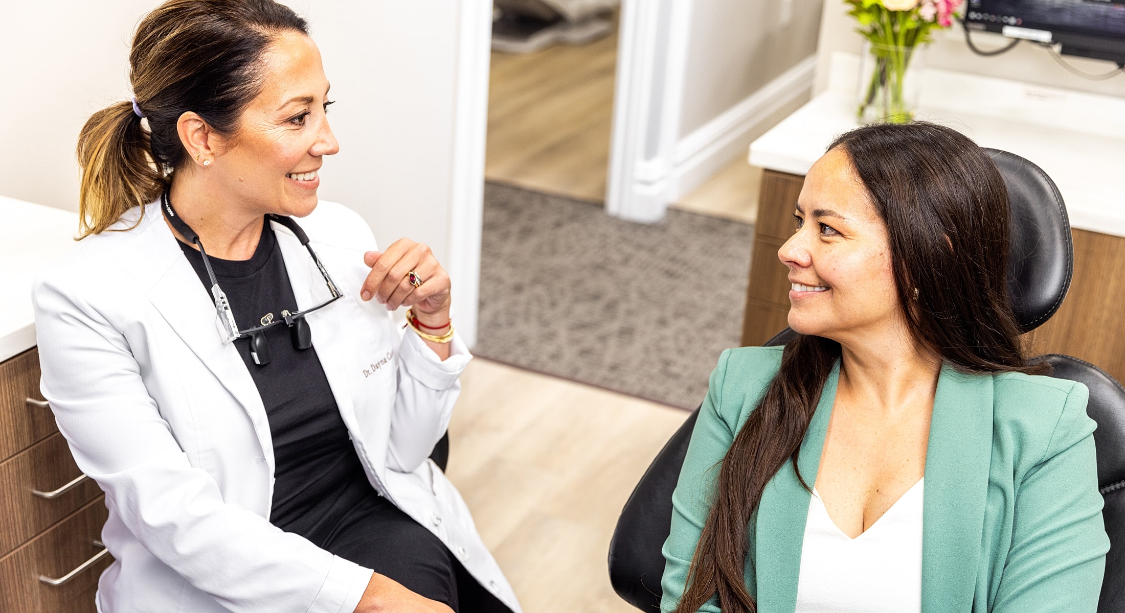 Dentist consulting with patient in dental office.