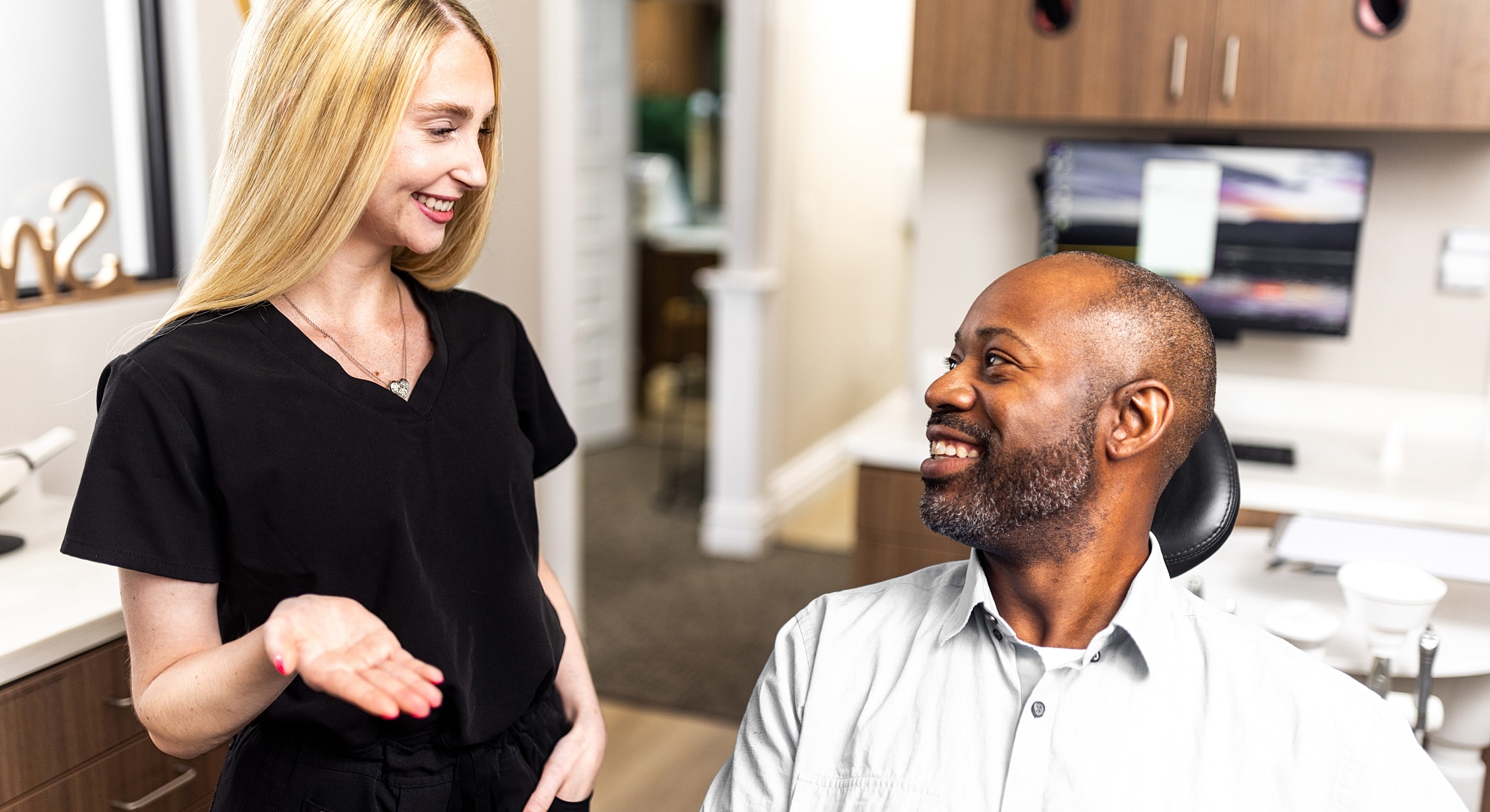 Dentist consulting with patient in dental office.