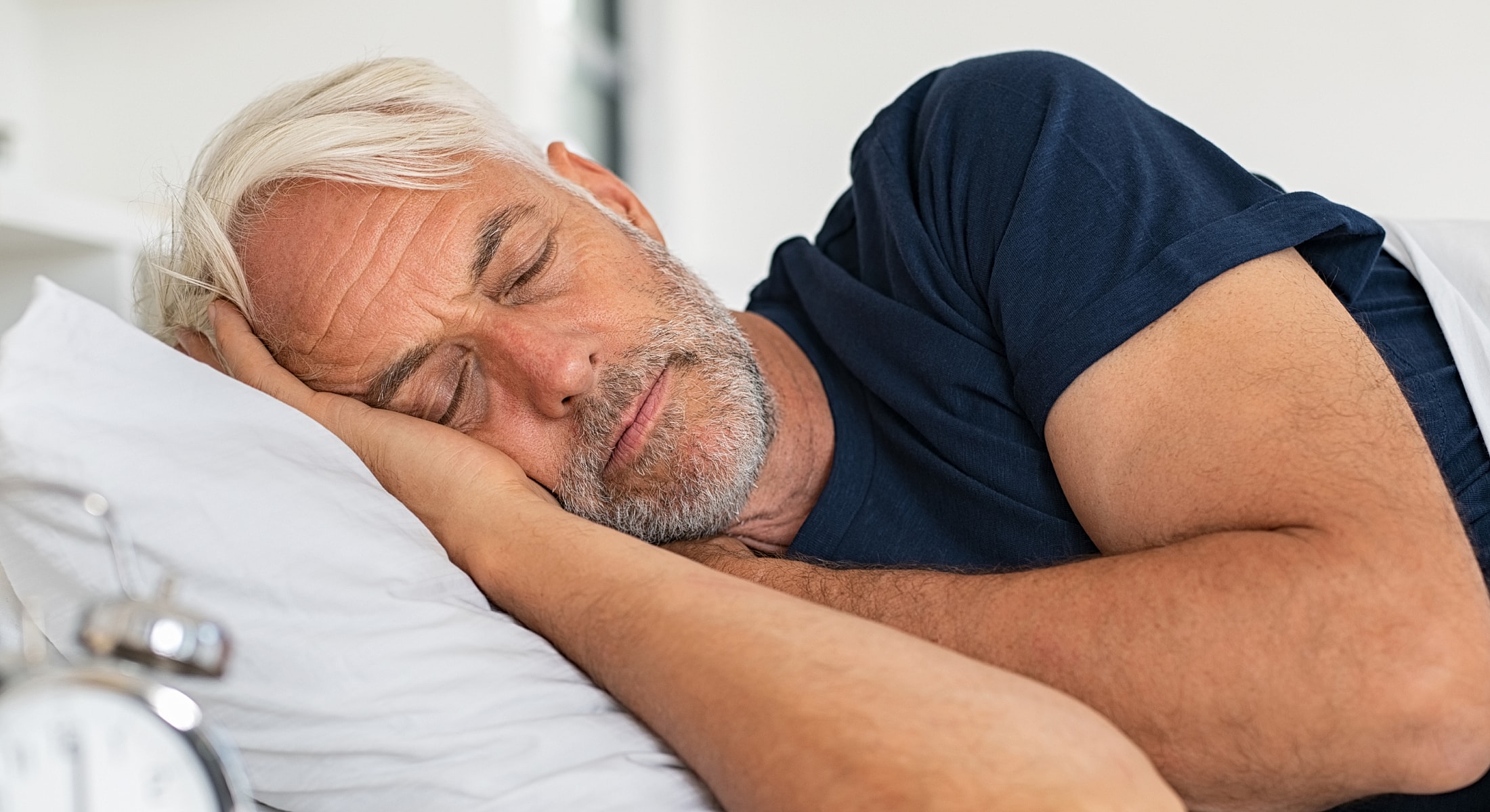 Man peacefully sleeping on a pillow.